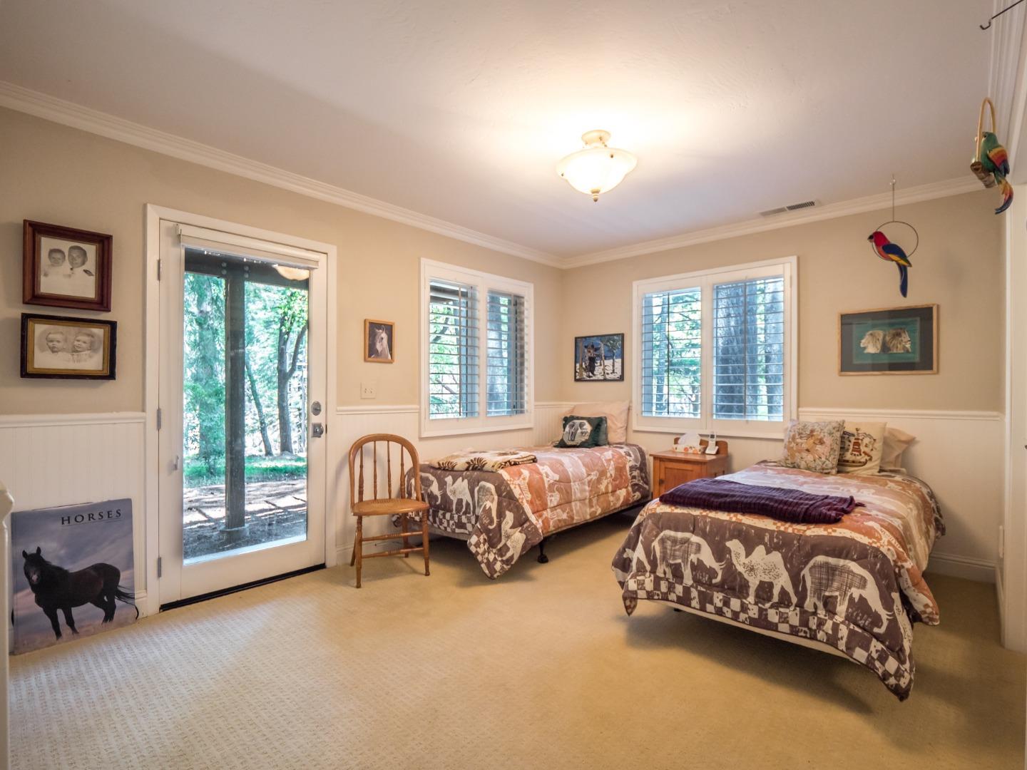 12445 Alba Road Ben Lomond, CA 95005 - Photo 31 of 37 a spacious bedroom with two beds and a window