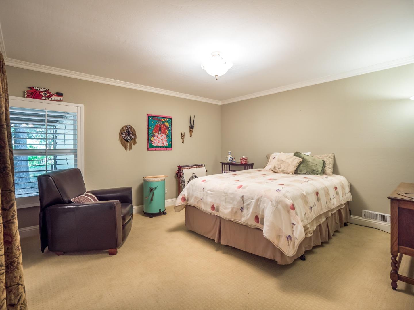 12445 Alba Road Ben Lomond, CA 95005 - Photo 32 of 37 a spacious bedroom with a bed and a couch