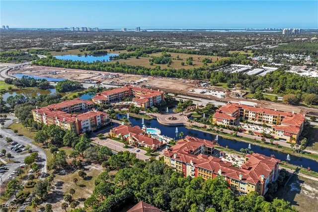 an aerial view of multiple houses with a yard