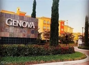 a sign board with buildings in the background