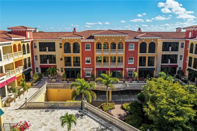 a view of an empty room and kitchen with a chandelier