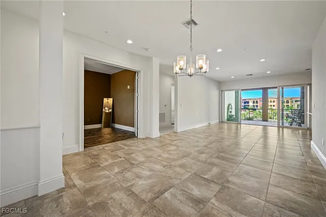 a kitchen with stainless steel appliances granite countertop a refrigerator a stove and a sink