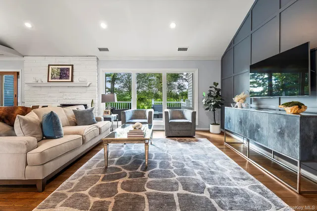 a living room with furniture a rug and a large window