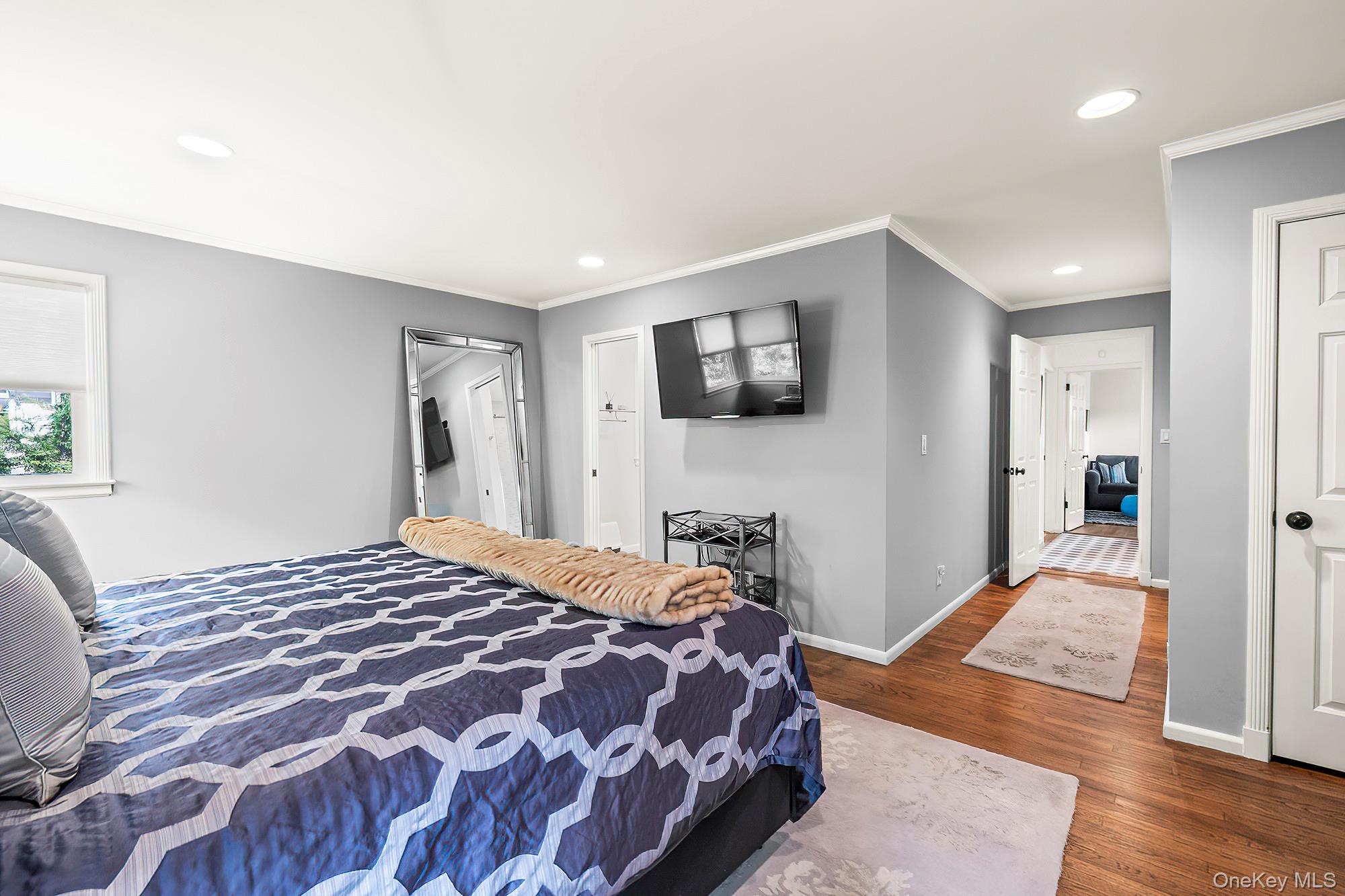 53 Country Ridge Drive Rye Brook, NY 10573 - Photo 18 of 50 a bedroom with a bed and a flat screen tv