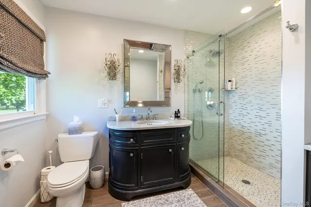 a bathroom with a sink toilet and shower