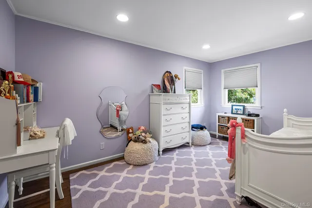 a bedroom with furniture and a wooden floor