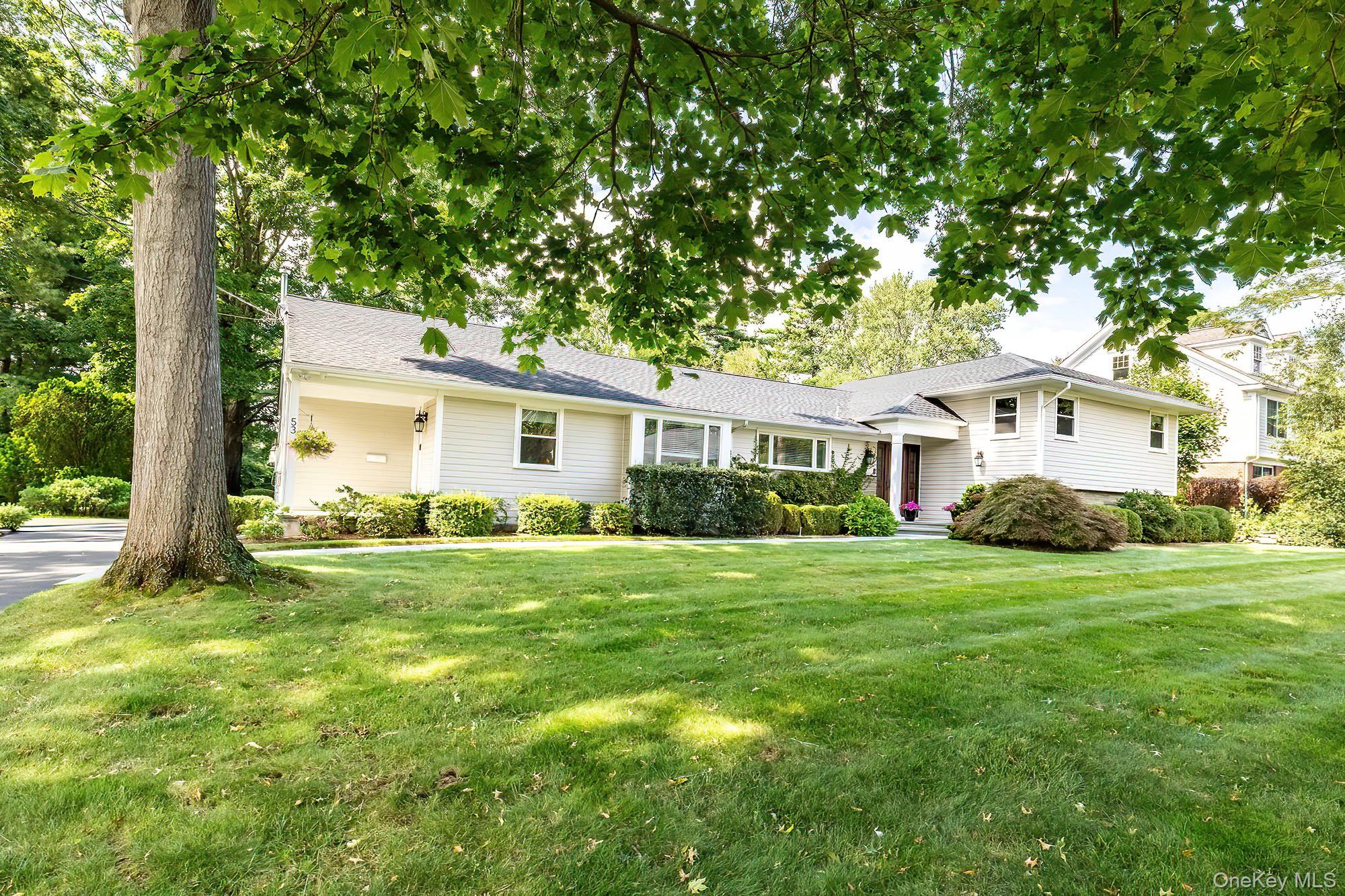 53 Country Ridge Drive Rye Brook, NY 10573 - Photo 2 of 50 a front view of a house with a yard and trees