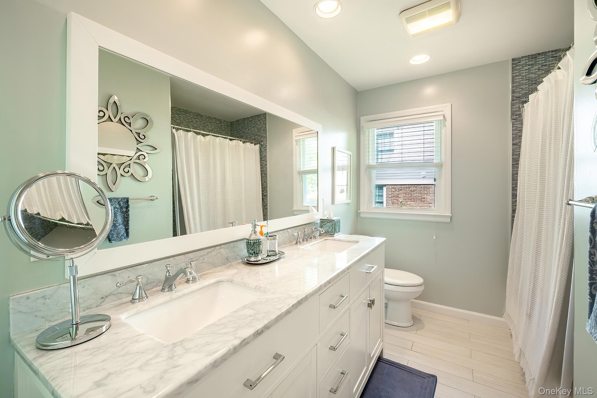 53 Country Ridge Drive Rye Brook, NY 10573 - Photo 22 of 50 a bathroom with a granite countertop bathtub sink vanity mirror and toilet