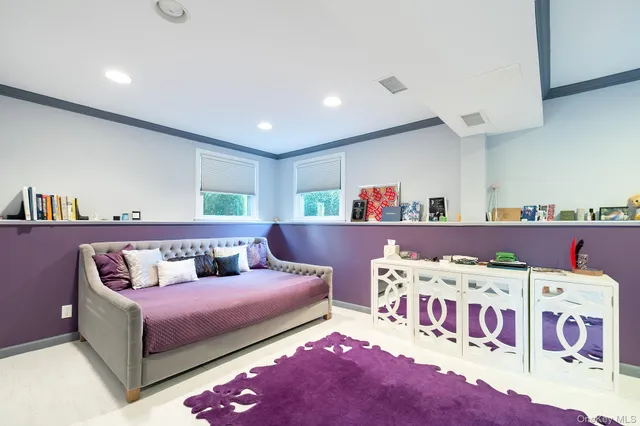 a bedroom with furniture and a rug