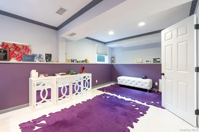 a living room with furniture and a baby crib