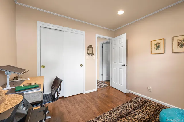 a bedroom with a bed and a desk