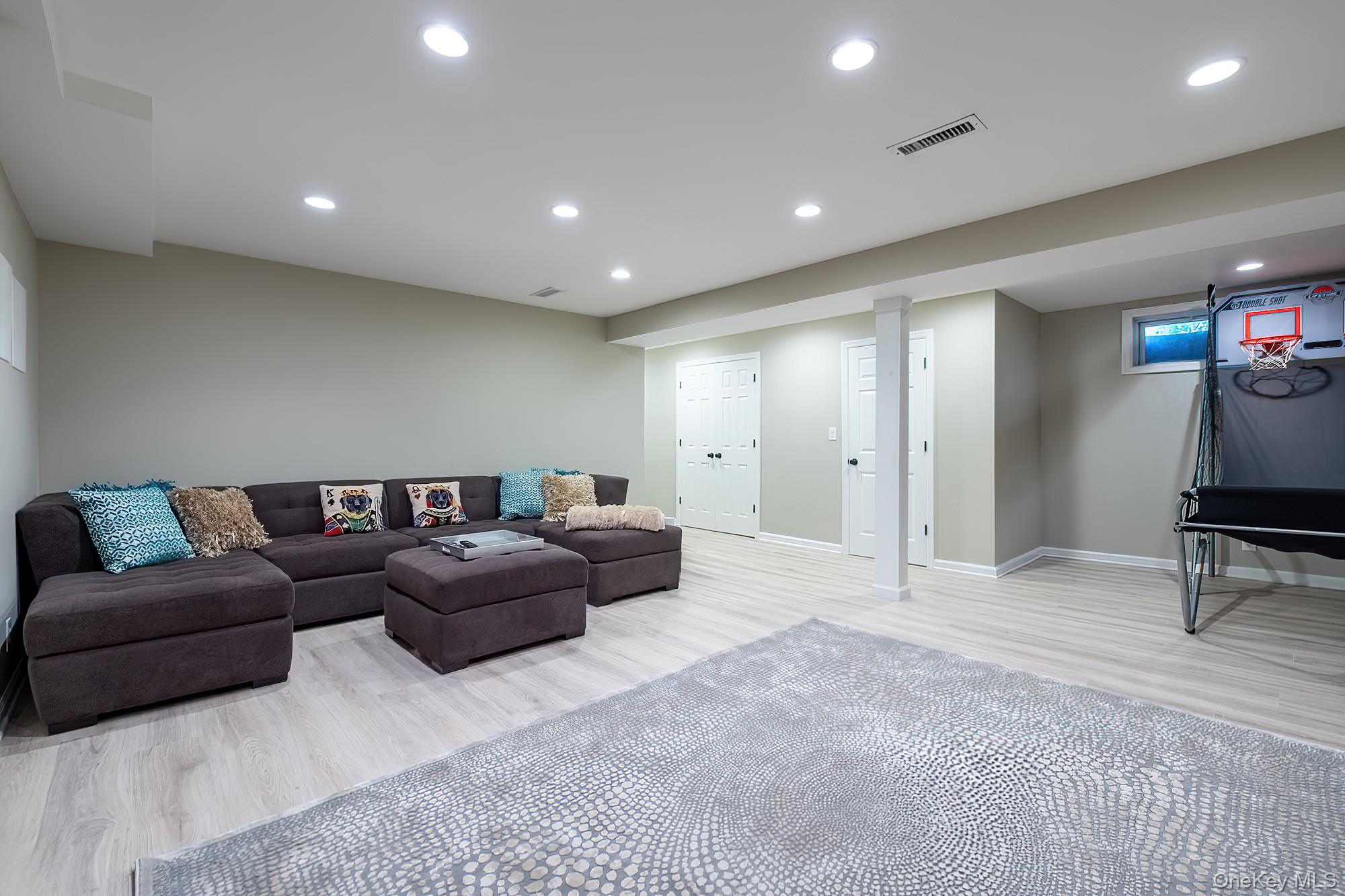 53 Country Ridge Drive Rye Brook, NY 10573 - Photo 33 of 50 a living room with furniture a mirror and a couch