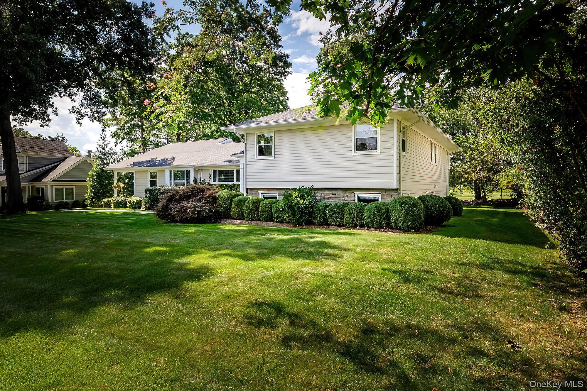 53 Country Ridge Drive Rye Brook, NY 10573 - Photo 40 of 50 a view of a house with a big yard and large trees
