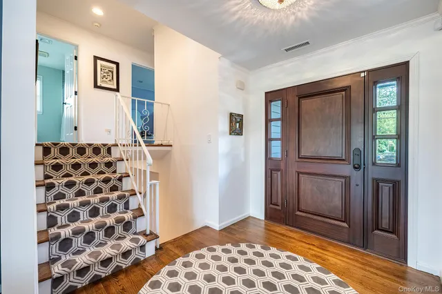 a view of a hallway with windows and stairs