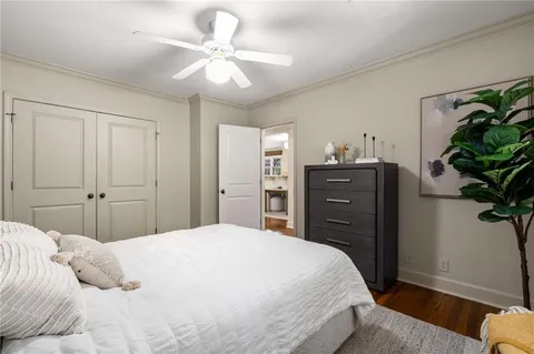 a bedroom with a bed and a potted plant