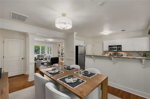 a view of a dining room with furniture window and wooden floor
