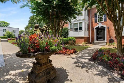 a view of a house with a yard and garden