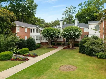 a view of a house with a yard and a garden