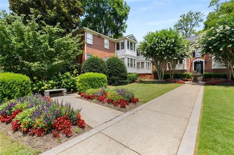 a front view of a house with a yard and fountain