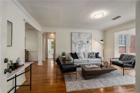 a living room with furniture and wooden floor