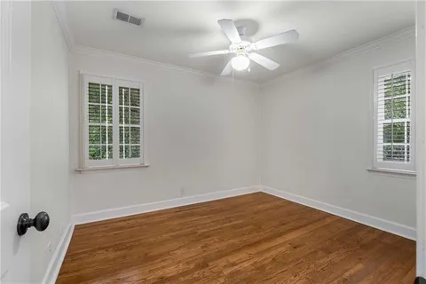 a view of a room with wooden floor and windows