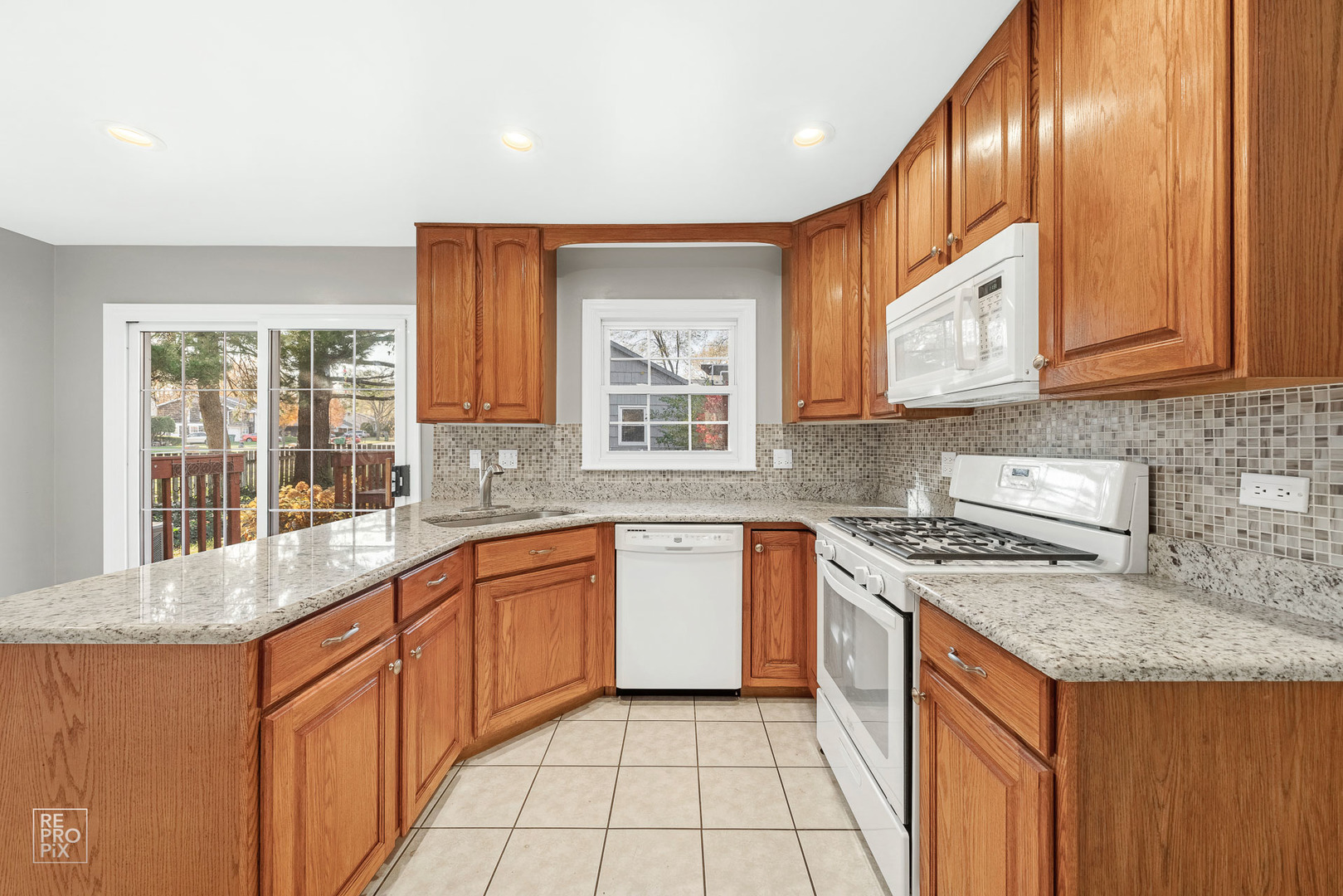 340 Weidner Road Buffalo Grove, IL 60089 - Photo 6 of 16 a kitchen with stainless steel appliances granite countertop wooden cabinets a sink and a stove