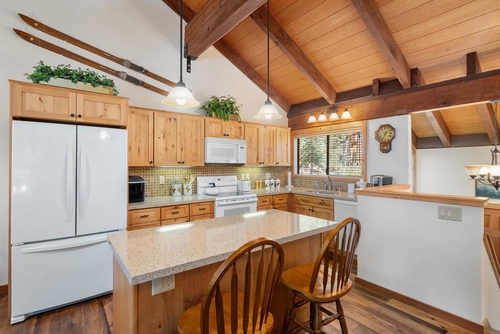 6038 Mill Camp Northstar, CA 96161 - Photo 1 of 28 a kitchen with stainless steel appliances granite countertop a refrigerator a sink dishwasher a stove and white countertops with wooden floor