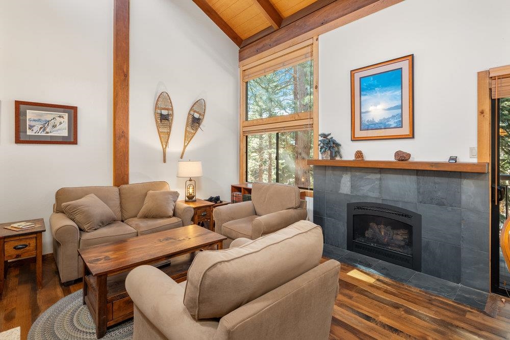 6038 Mill Camp Northstar, CA 96161 - Photo 23 of 28 a living room with furniture a fireplace and a large window