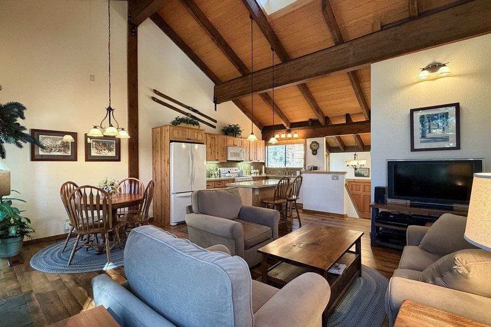 6038 Mill Camp Northstar, CA 96161 - Photo 25 of 28 a living room with furniture a flat screen tv and kitchen view