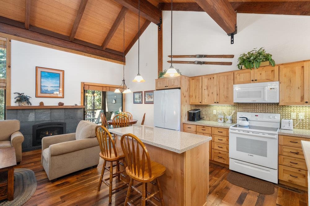 6038 Mill Camp Northstar, CA 96161 - Photo 26 of 28 a kitchen with stainless steel appliances granite countertop a stove a sink dishwasher and a refrigerator with wooden floor