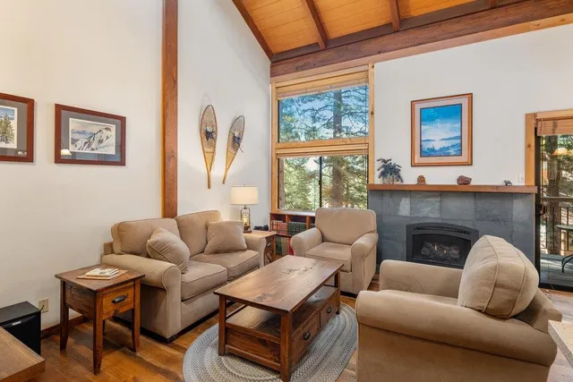 a living room with furniture a fireplace and next to a window