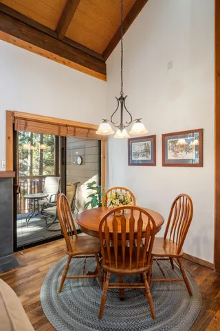 a dining room with furniture a rug and wooden floor