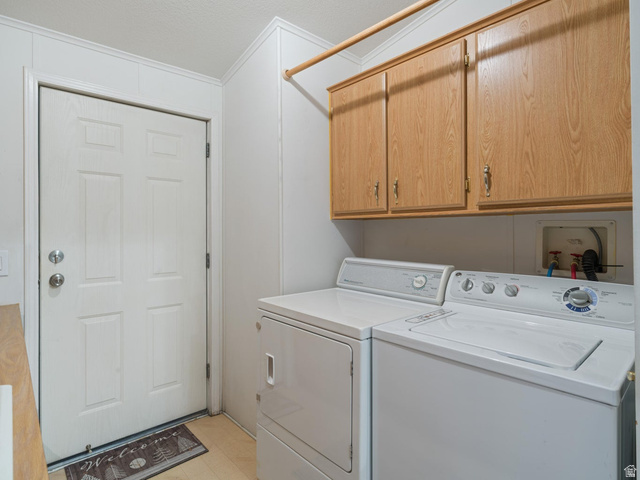 3941 West 40 North Hurricane, UT 84737 - Photo 33 of 55 Dedicated laundry area featuring overhead wood-finish cabinetry, a utility rod, and panel-style walls