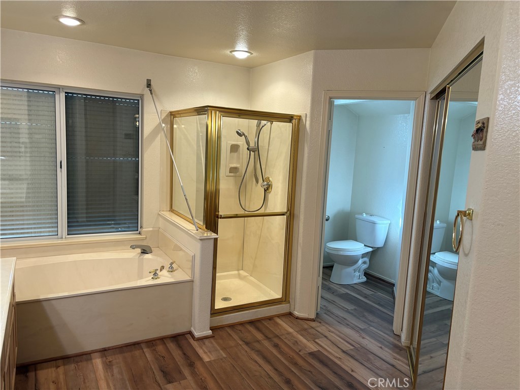 40135 Festival Road Murrieta, CA 92562 - Photo 16 of 35 a bathroom with a tub toilet and shower