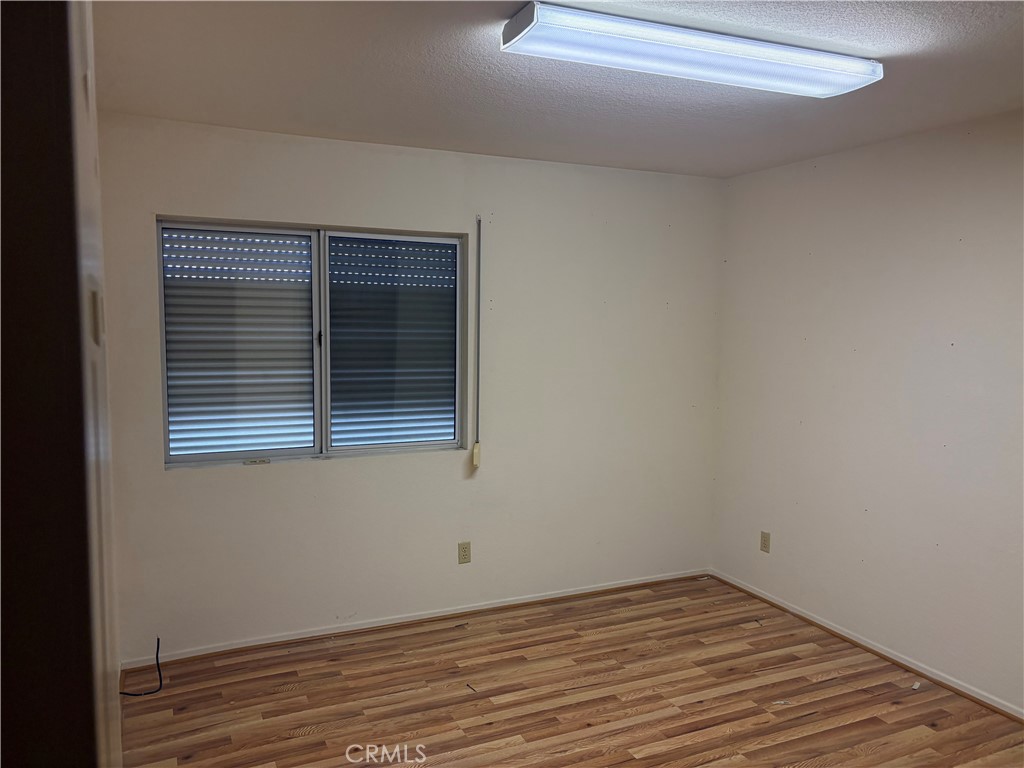 40135 Festival Road Murrieta, CA 92562 - Photo 17 of 35 a view of an empty room with wooden floor and a window