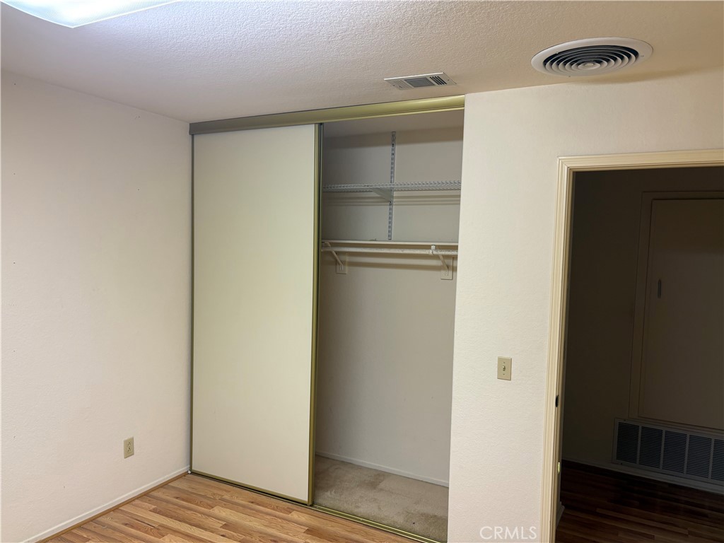 40135 Festival Road Murrieta, CA 92562 - Photo 18 of 35 a view of walk in closet with empty racks