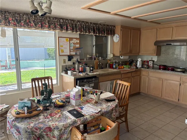 a kitchen with a table chairs and a wooden floor