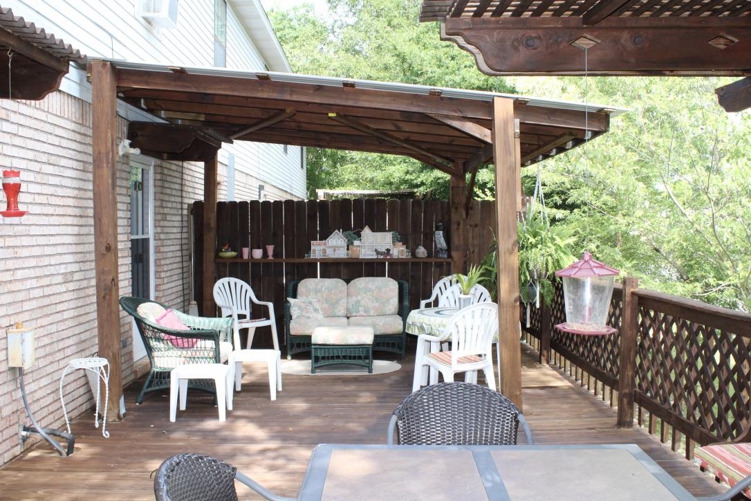 705 Valley Road Crestview, FL 32539 - Photo 18 of 20 a view of a patio with table and chairs potted plants with wooden floor
