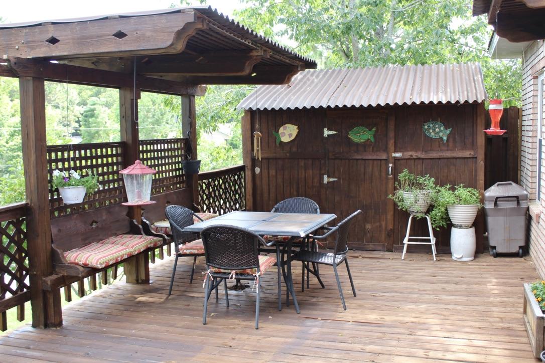 705 Valley Road Crestview, FL 32539 - Photo 19 of 20 a view of a patio with table and chairs potted plants with wooden floor