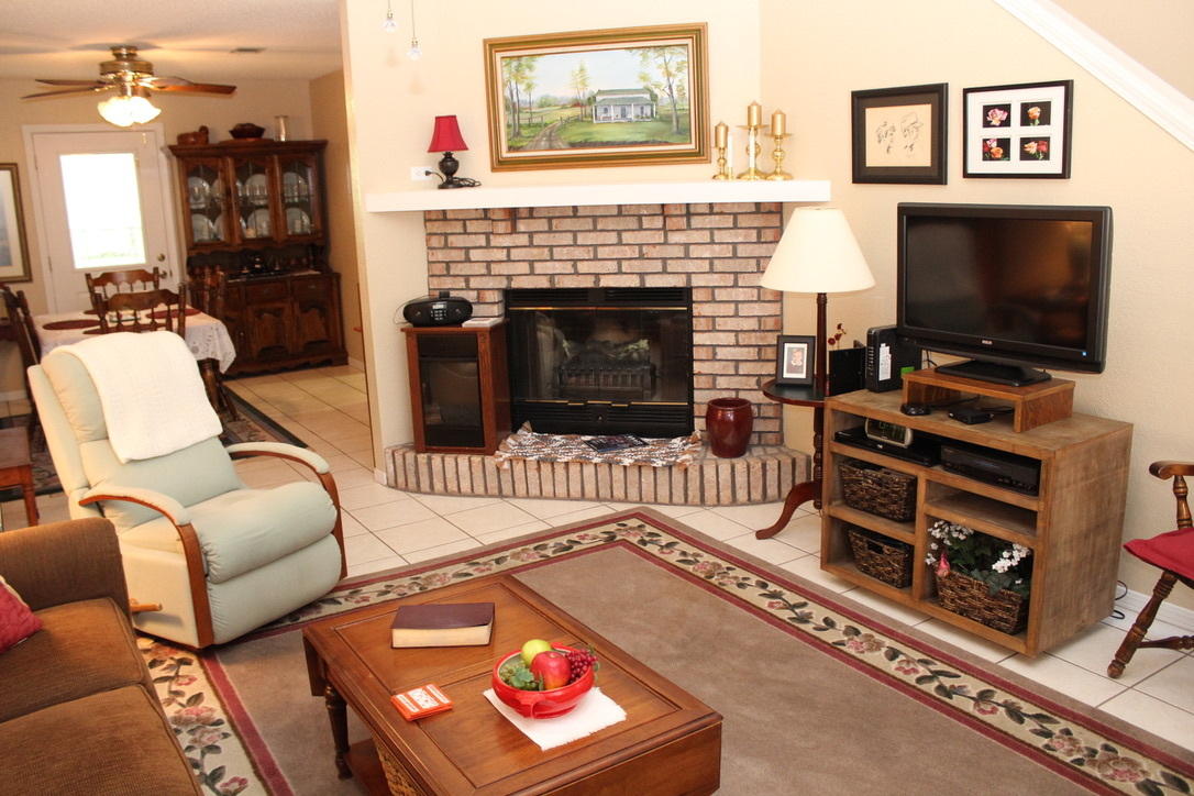 705 Valley Road Crestview, FL 32539 - Photo 3 of 20 a living room with furniture a flat screen tv and a fireplace