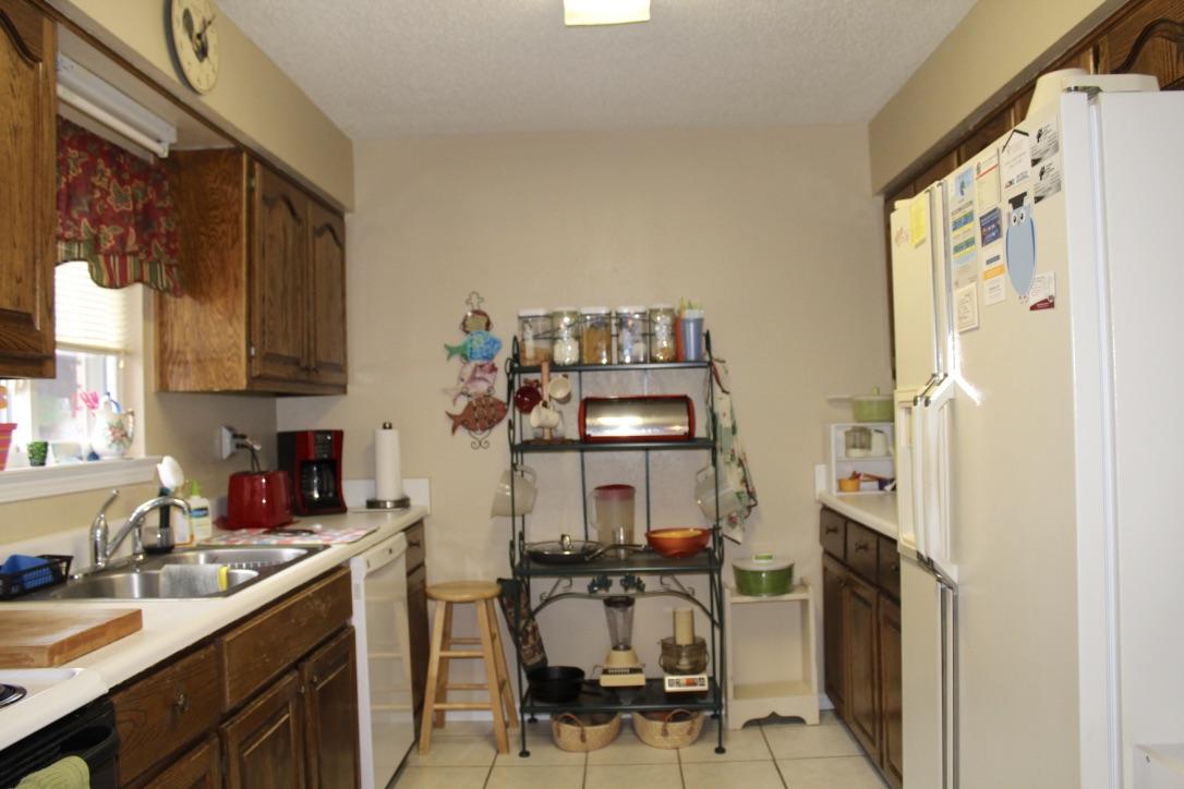 705 Valley Road Crestview, FL 32539 - Photo 7 of 20 a kitchen with stainless steel appliances granite countertop a refrigerator and a stove top oven