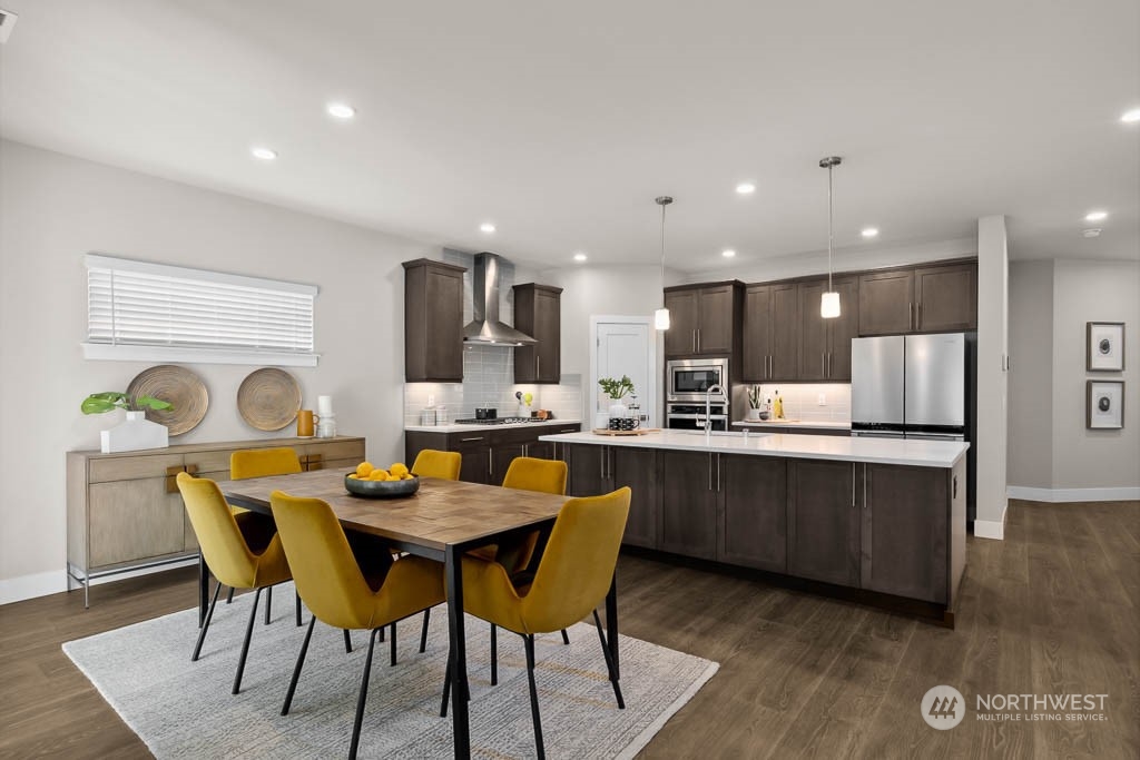 22825 20th Place West Bothell, WA 98021 - Photo 13 of 35 a kitchen with a dining table chairs and wooden floor