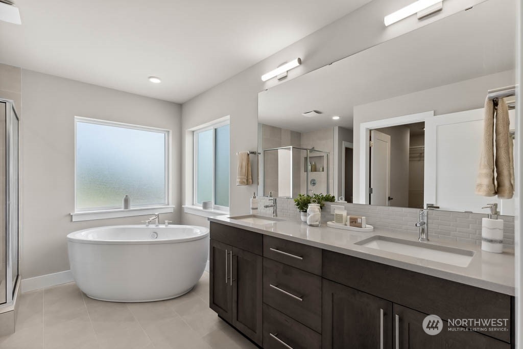 22825 20th Place West Bothell, WA 98021 - Photo 21 of 35 a large bathroom with a double vanity sink a bathtub and mirror