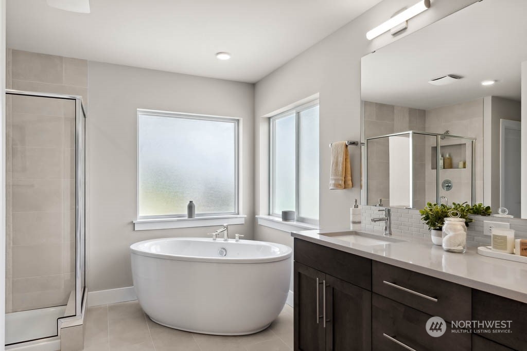 22825 20th Place West Bothell, WA 98021 - Photo 22 of 35 a bathroom with a double vanity sink a mirror and a bathtub