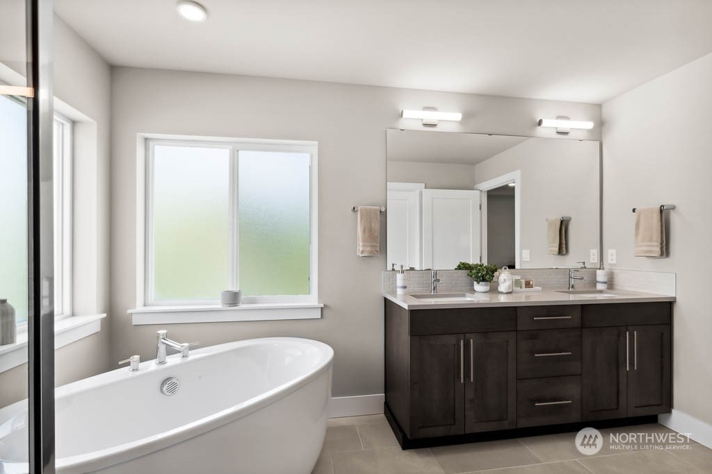 22825 20th Place West Bothell, WA 98021 - Photo 24 of 35 a bathroom with a tub sink and mirror