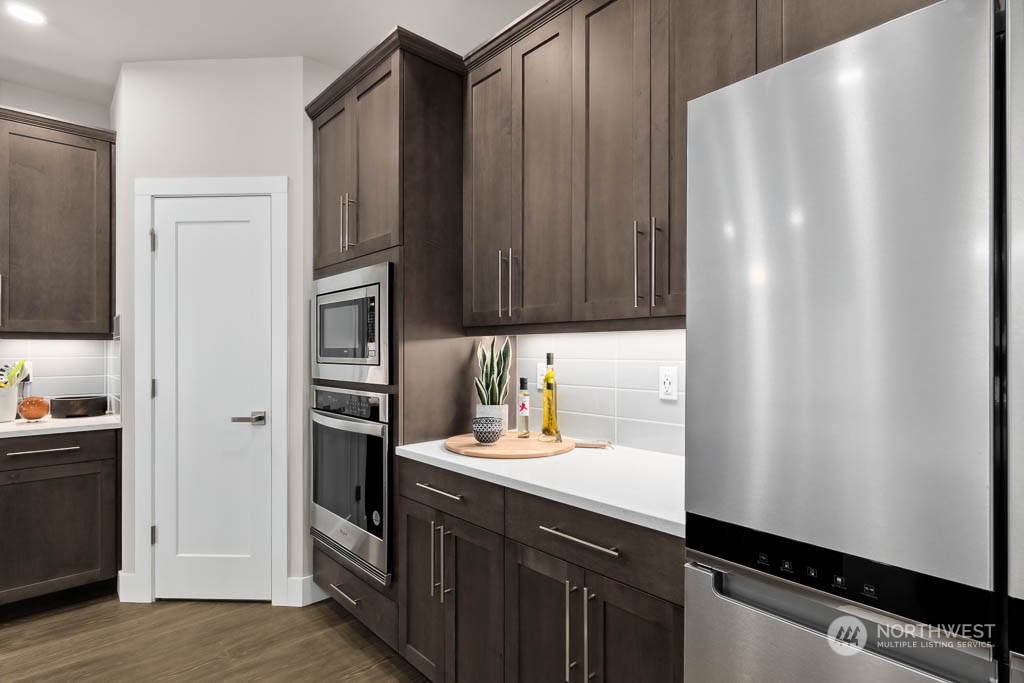 22825 20th Place West Bothell, WA 98021 - Photo 7 of 35 a kitchen with stainless steel appliances a refrigerator and cabinets