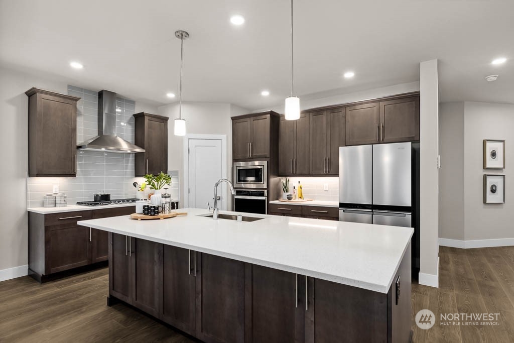 22825 20th Place West Bothell, WA 98021 - Photo 10 of 35 a kitchen with kitchen island a sink stainless steel appliances and cabinets