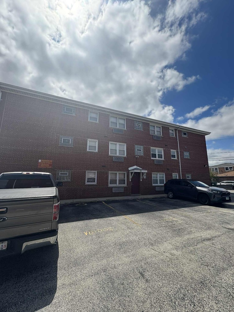 8000 South Pulaski Road, Unit 201 Chicago, IL 60652 - Photo 1 of 9 a front view of a house with a yard