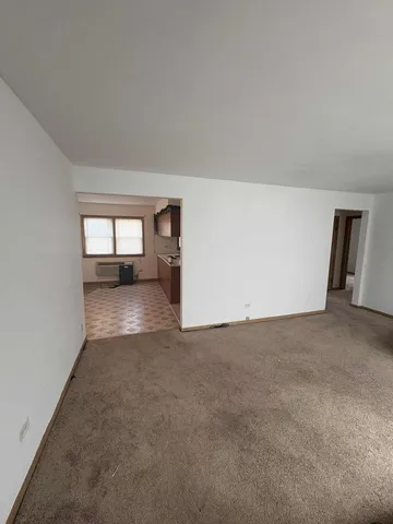 a view of wooden floor and windows in a room