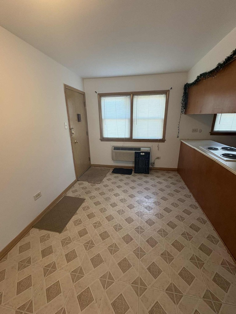 8000 South Pulaski Road, Unit 201 Chicago, IL 60652 - Photo 3 of 9 a bedroom with a bed and a flat screen tv